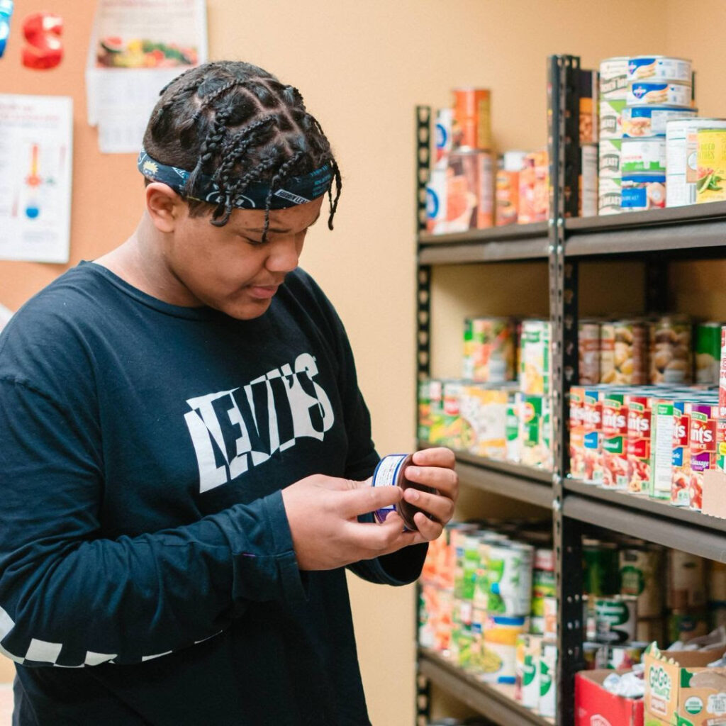 A young HEARTH resident shopping in the pantry