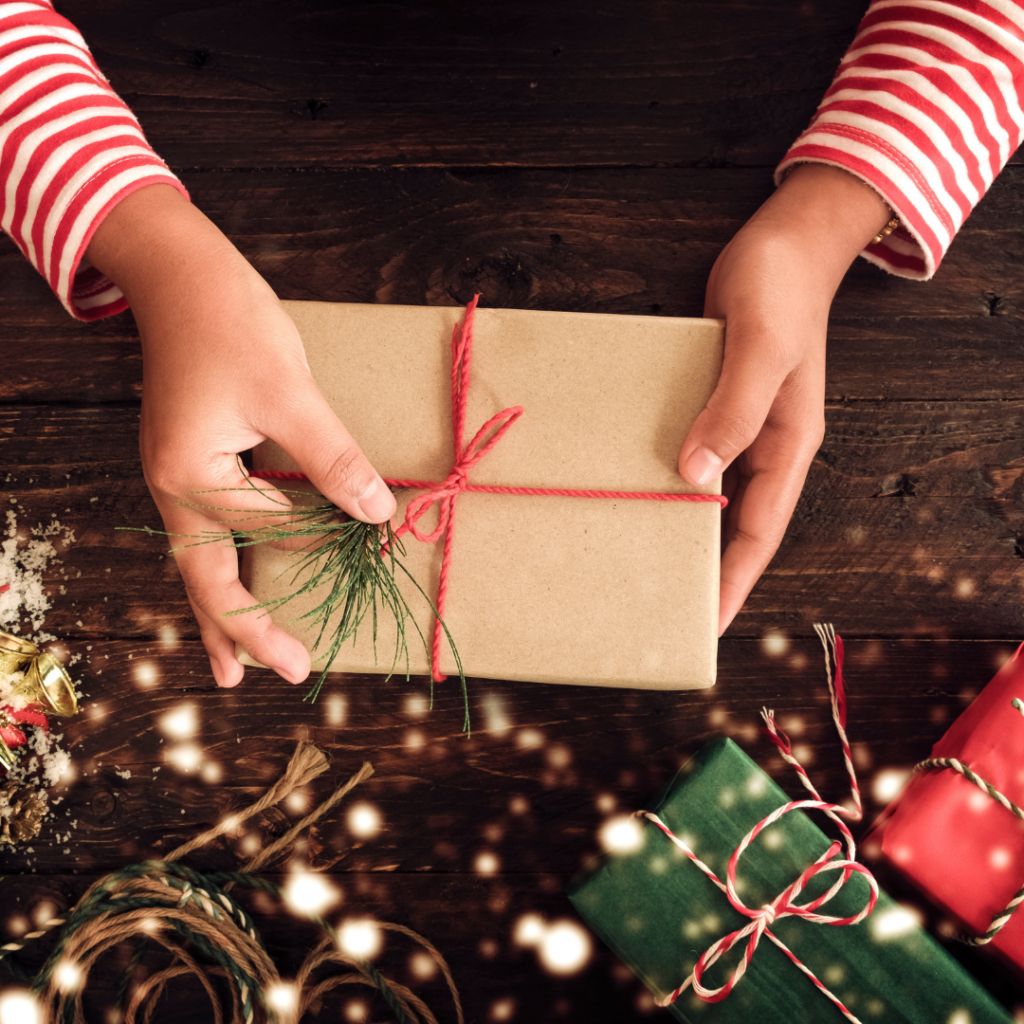 Close up of hands holding a nicely wrapped holiday gift