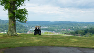 Golfers-in-a-golf-cart-overlooking-valley-below