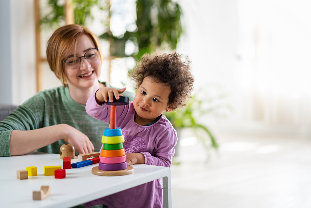 Child playing with colorful building blocks