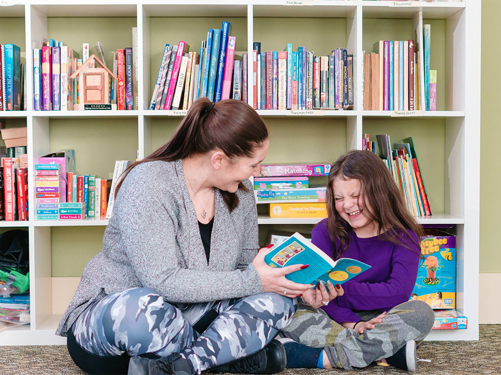 Mother and child reading a book together