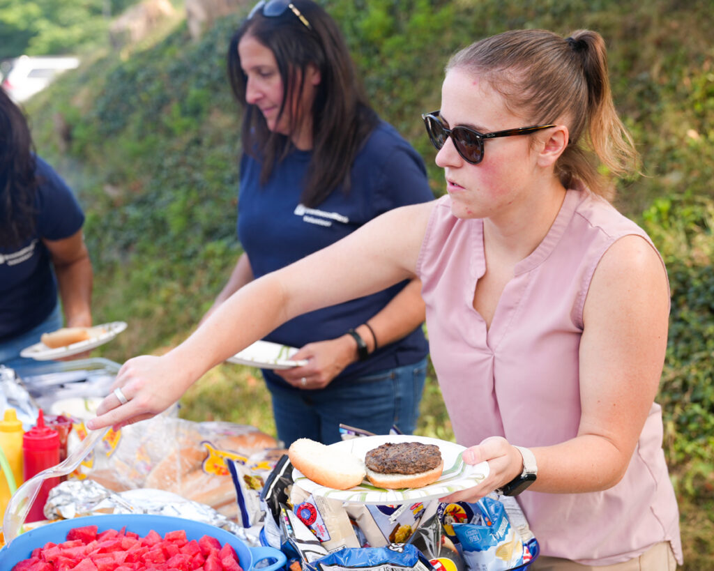 Volunteer serving food at a picnic